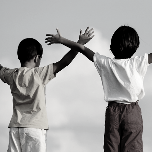 Two children with their arms outstretched